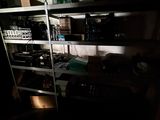 a dark room with a shelf full of electronic equipment