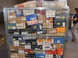 a metal cart with many boxes on it in a warehouse