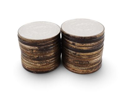 a close up of a stack of coins on a white surface