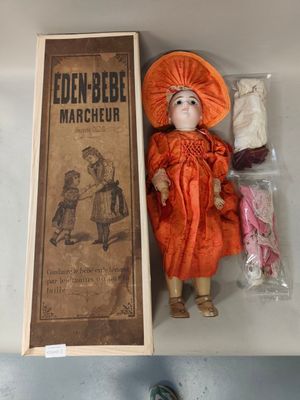 a doll that is sitting on a table next to a book