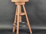 a wooden stool with a wooden seat on a grey background