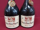 two bottles of wine sitting on top of a table next to each other