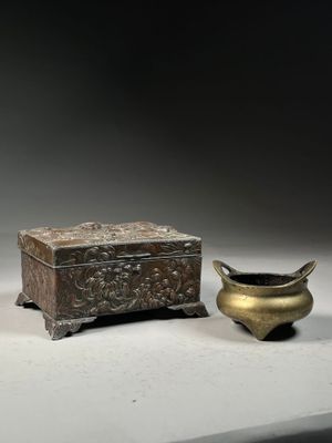 a small box and a small bowl sitting next to each other