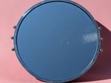 blue round mirror against a pink background
