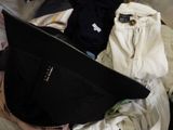 une valise remplie de vêtements posée sur un lit