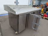 a stainless steel kitchen island with a granite counter top