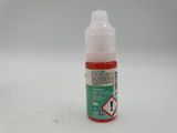 a close up of a bottle of liquid on a white surface