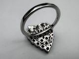 silver ring with a skull and a skull head in the middle