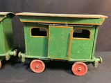 two green toy trains sitting next to each other on a table