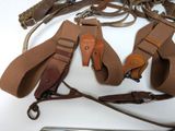 a lot of belts and a cell phone on the table