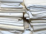 a pile of folded white linens on a table