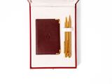 an image of a pen and a notebook in a box