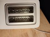a toaster with two toasters in it on a table