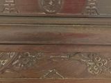 a wooden table with carvings on the top of it