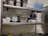a kitchen with a lot of dishes on the shelves