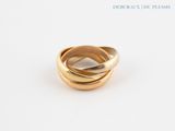 an image of a gold ring on a white surface