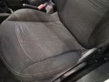 a close up of a seat in a car with a remote control