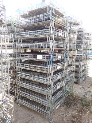 a large pile of scaffolding in the middle of a field