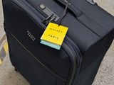 a suitcase with a tag on it sitting on the ground