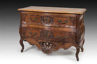 an old wooden chest of drawers with carvings on the drawers