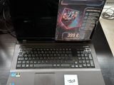 a laptop computer sitting on a table with a box on top of it