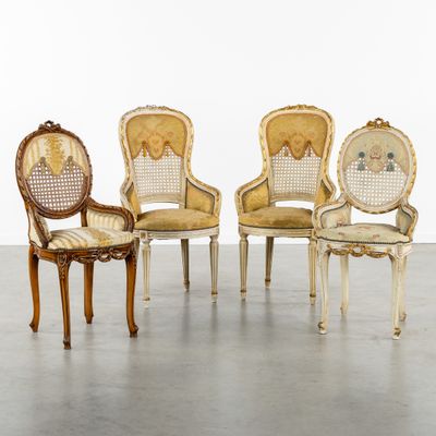 four antique chairs are lined up in a row on the floor