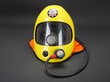 a close up of a yellow gas mask on a black background