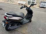 a scooter parked in front of a building on the street