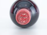 a close up of a wine bottle on a white surface