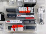 a lot of different pens and ink pens in a box
