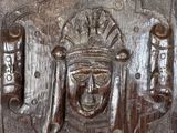 a wooden carving of a man with a crown on his head