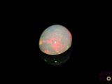 an image of a white oplite in the dark