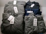 four pairs of men ' s clothing are on display in a store