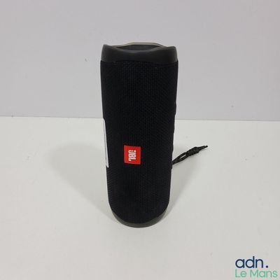 a close up of a black speaker on a white surface