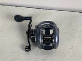 a close up of a fishing reel on the ground