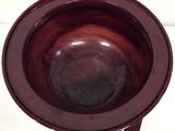 a brown bowl sitting on top of a white table