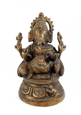 brass statue of a seated gan on a pedestal on a white background