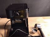 a coffee maker that is sitting on a wooden table