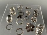 a clear display case with a lot of rings on it