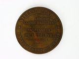 an old bronze coin that has been placed on a white surface
