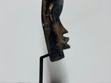 a close up of a sculpture of a person ' s face on a stand