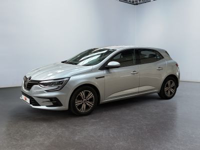 a silver car parked in a white room with a black floor