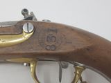an old gun with a brass handle on a white background