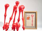 a picture of a group of red sculptures next to a picture frame
