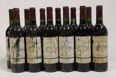 six bottles of wine are lined up in a row on a white surface