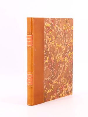 a brown book with a marbled cover on a white surface