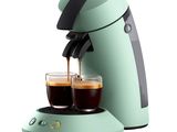 an image of a green coffee maker with two cups of coffee