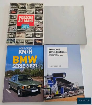 two books on a table with a car in the background