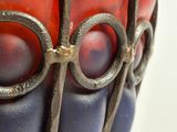 a close up of a vase with a red and blue design