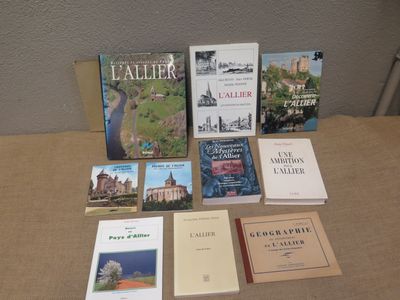 several books are sitting on a table in front of a wall